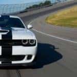 White 2018 Challenger with black racing stripe on a track