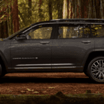 Dark gray 2024 Jeep Grand Cherokee in woods