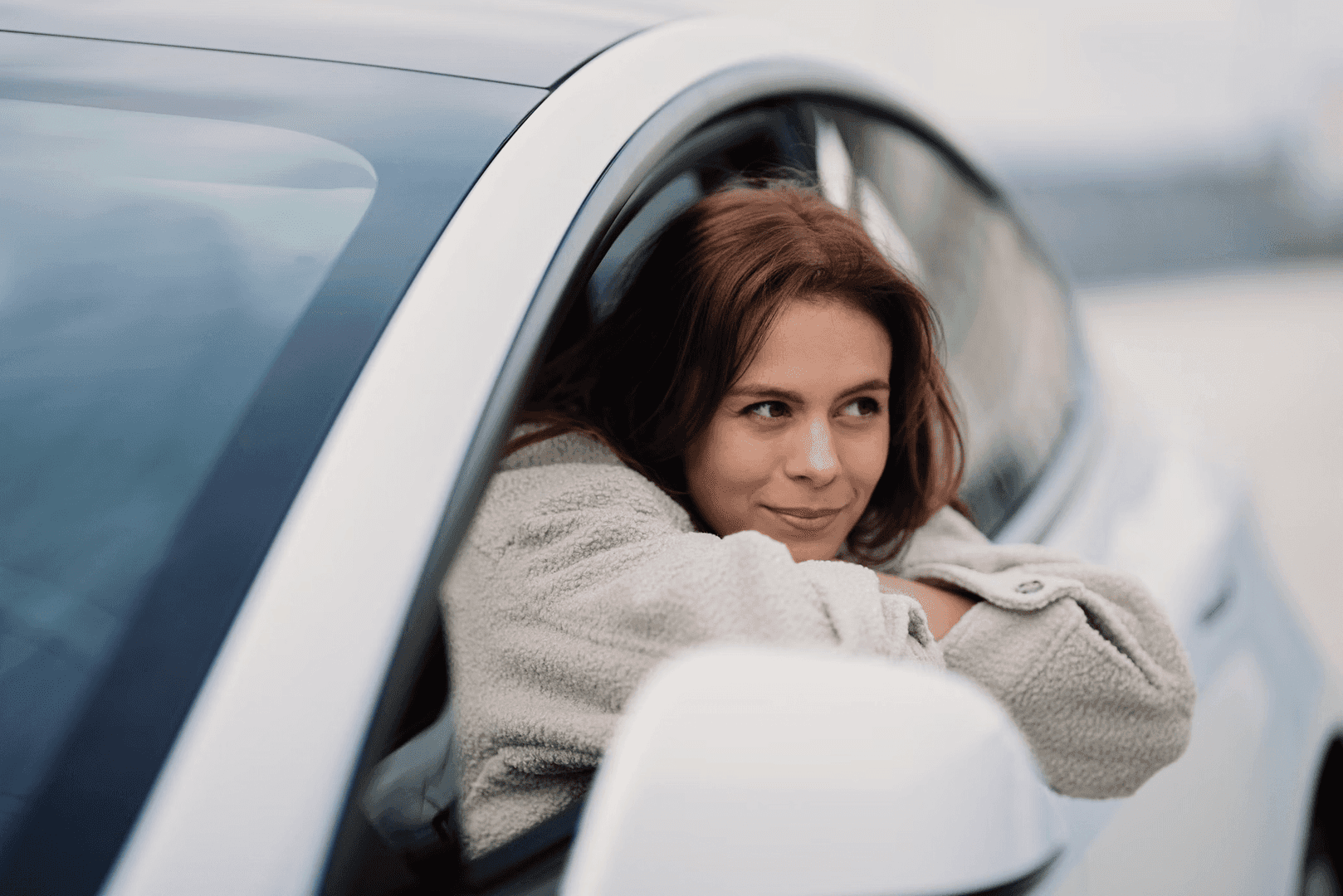 Woman leaning out of car window