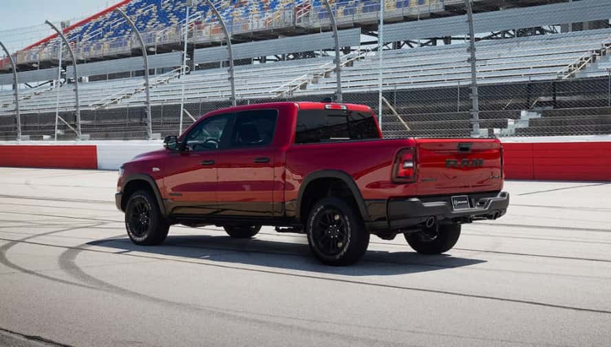 A red 2026 Ram 1500 truck at a race track
