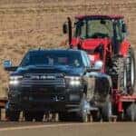 Dodge Ram hauling tractor in desert