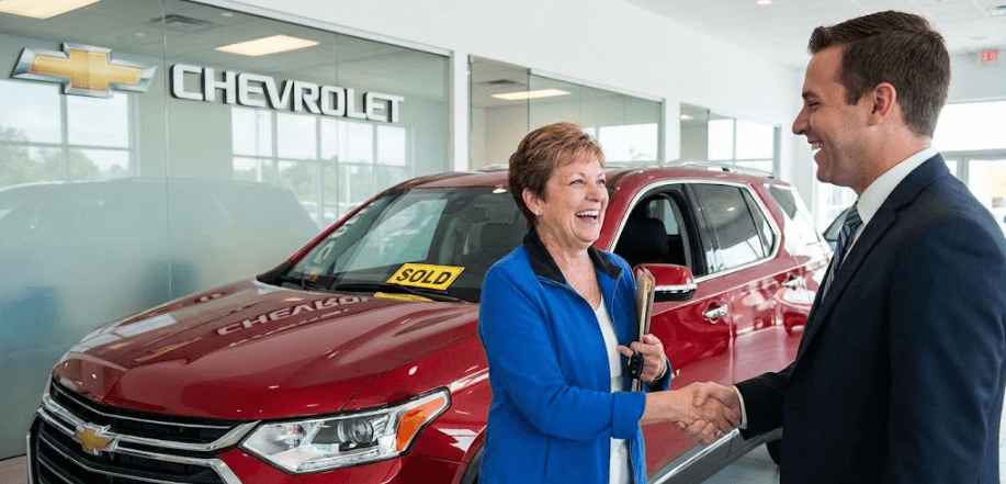 salesperson shaking customers hand after purchase