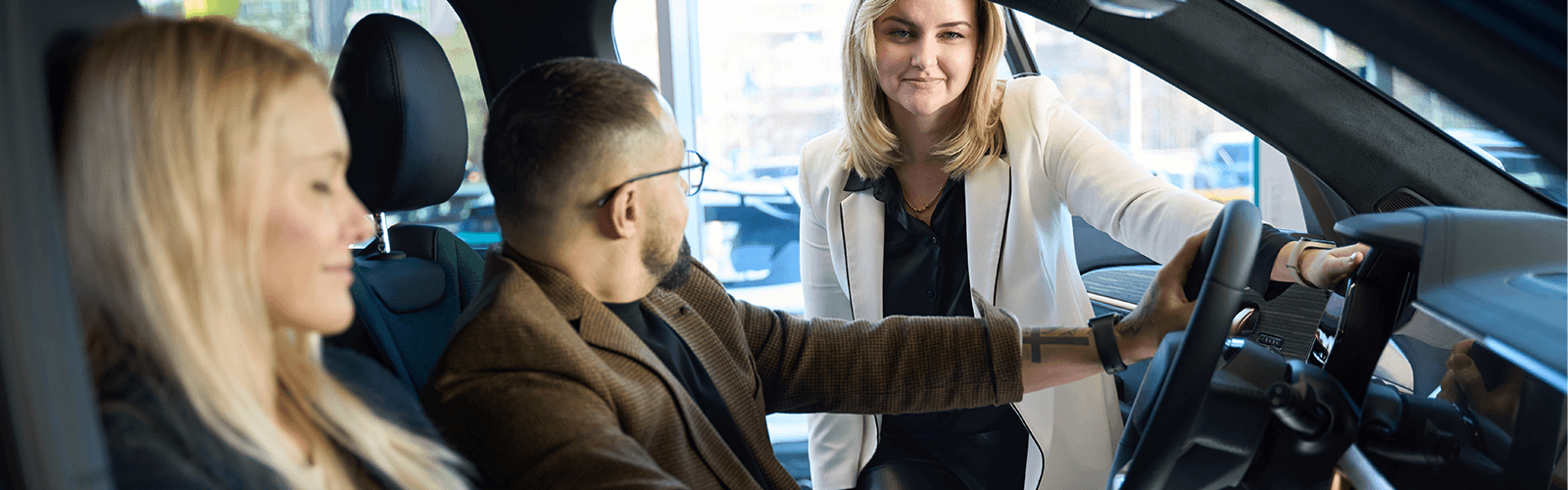 sales-person-showing-customers-a-vehicle