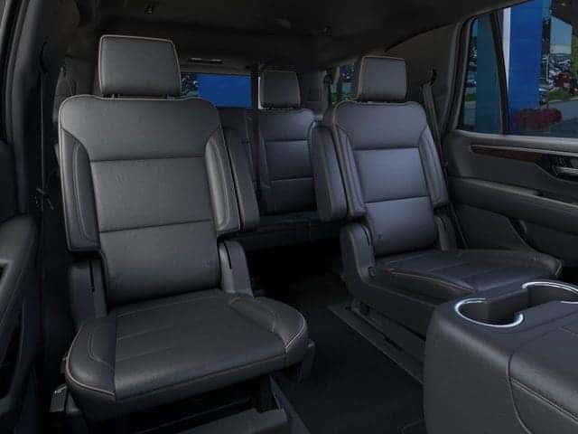 2026 Chevrolet Tahoe with rear liftgate open showing third-row seating and cargo space for a family