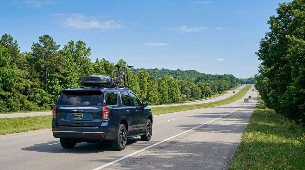 2026 Chevrolet Tahoe on a tree-lined Green Country highway near Tulsa with rolling green hills