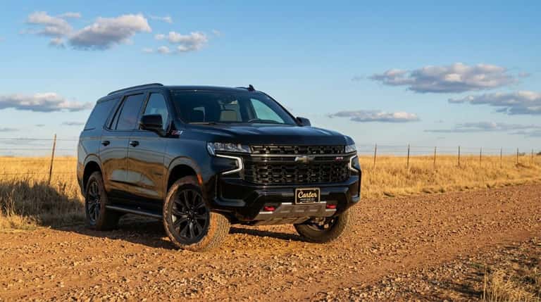 2026 Chevrolet Tahoe Z71 in black on a red-dirt Oklahoma road with all-terrain tires