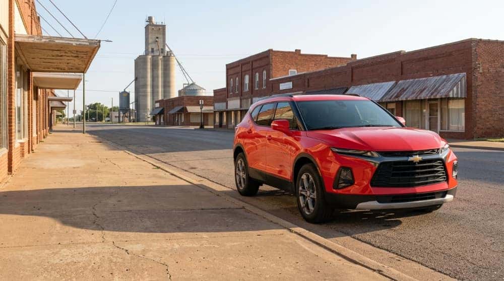 Red Chevrolet Blazer parked on a small-town Oklahoma main street in morning light