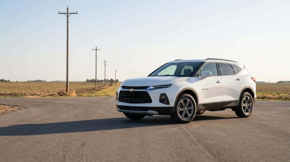 White Chevrolet Blazer parked at a rural Oklahoma crossroads in late afternoon light