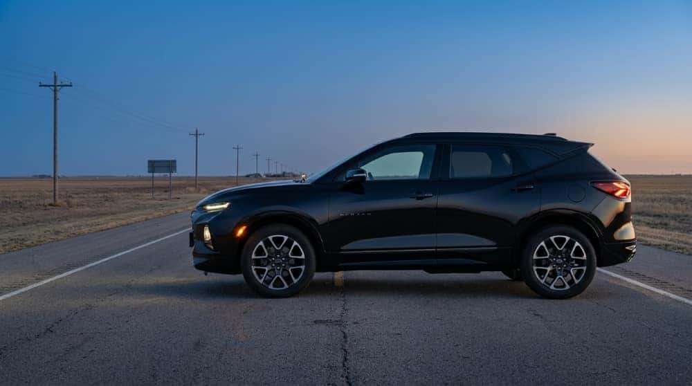 Black Chevrolet Blazer RS in side profile on a two-lane highway outside El Reno at blue hour