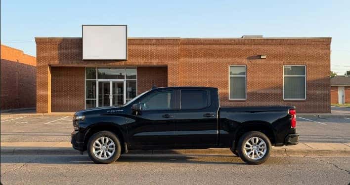 Chevrolet Silverado 1500 parked outside a local Oklahoma credit union branch, Carter Chevrolet finance folder on the tailgate