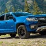 A blue 2022 Chevy Colorado Z71 is shown parked on mountain trail.