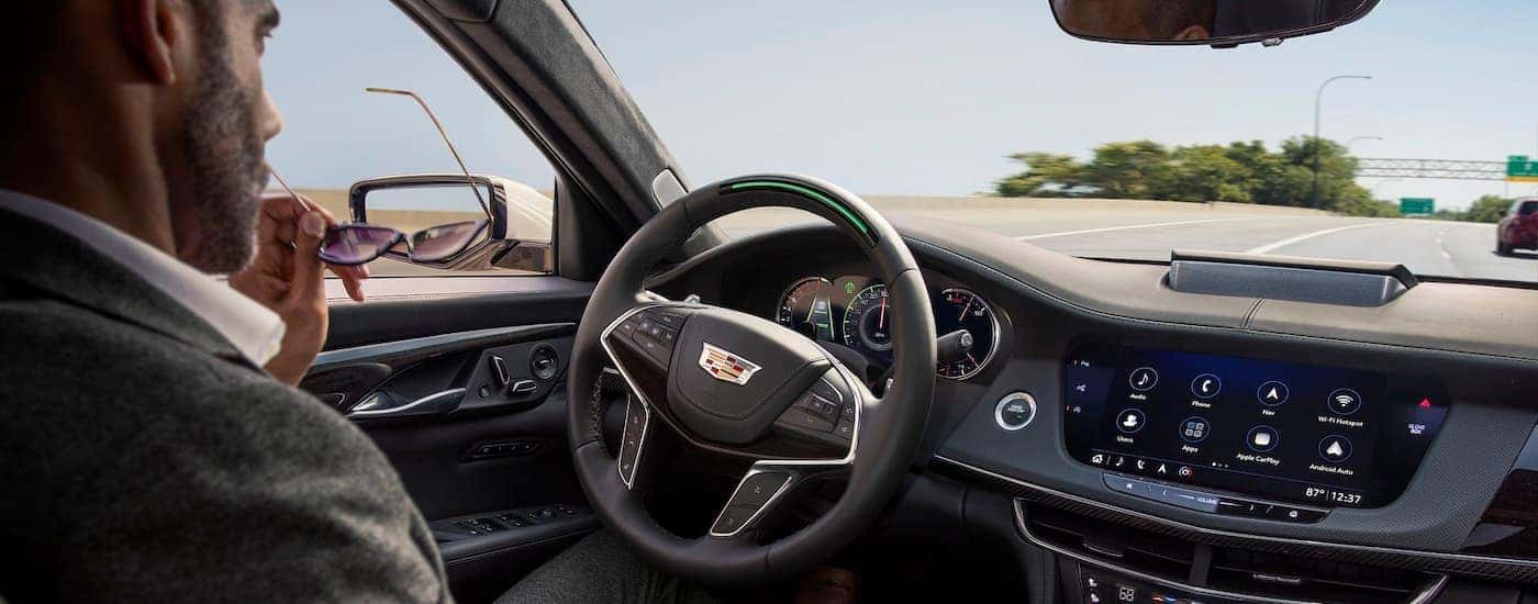 A person is shown using the super cruise feature in a 2018 Cadillac CT6.