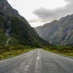 Long road cut through mountains.