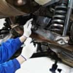 auto mechanic at car suspension repair work