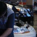 Honda technician working under hood of car