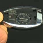 Closeup of open Mercedes-Benz key fob and battery