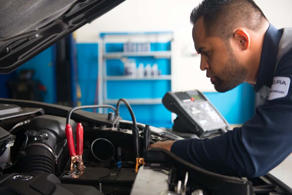 Acura service technicial performing battery test