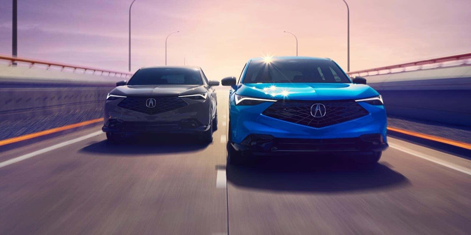 Two 2026 Acura ADX SUVs driving side by side on a bridge at dusk
