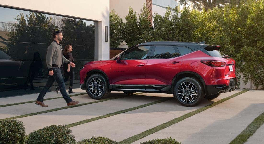 2025 Chevrolet Blazer RS exterior in red parked outside modern home