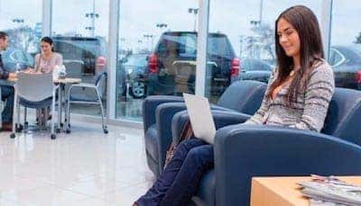 Customer relaxing in Greg Hubler Chevrolet dealership lounge while waiting for vehicle service