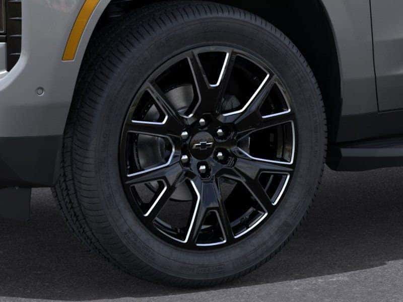 Close-up of black alloy wheel design on 2025 Chevy Tahoe at Greg Hubler Chevrolet Camby IN