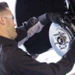 Certified Chevrolet technician performing brake inspection in Camby IN