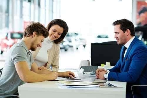 Beautiful young couple signs documents