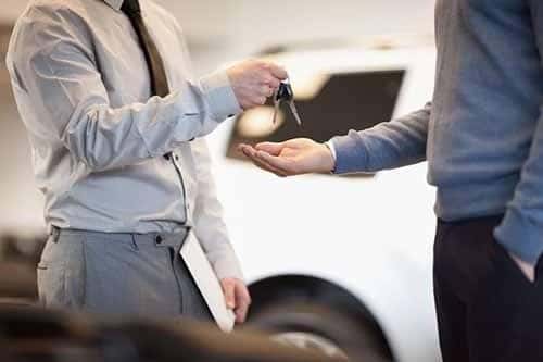 Man giving keys to another man