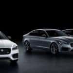 three xf sedans in silver gray and black against black backdrop