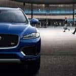 Jaguar Model Parked in Front of Office Building