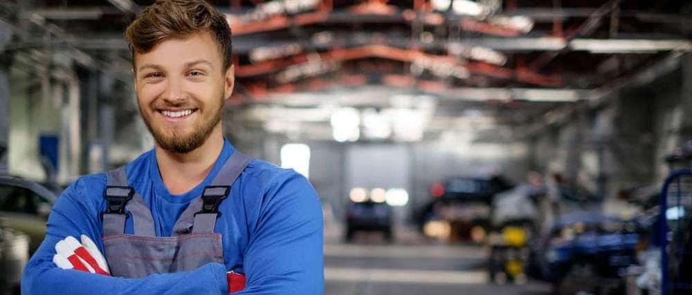 Cheerful serviceman in a car workshop