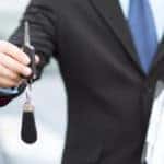 Man with car key outside
