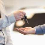 Man giving keys to another man