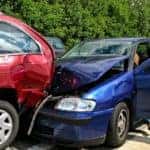 Blue sedan got into a rear-end collision with a red minivan