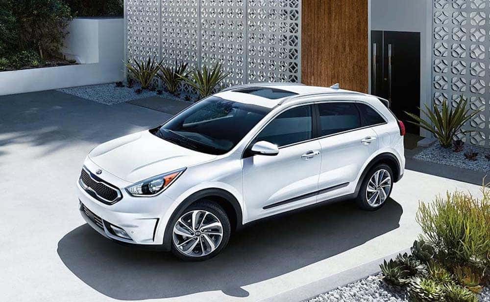 white Kia Niro parked in a driveway