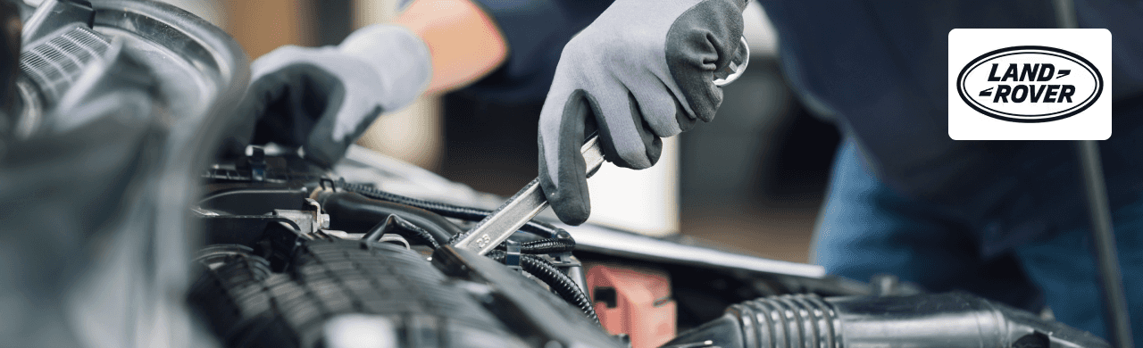 Land Rover technician performing an oil change using factory-certified tools at Land Rover Dayton