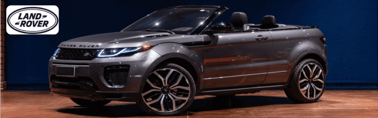 Land Rover Evoque Convertible parked along a scenic Dayton parkway, top down, showcasing its modern design.