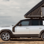 Land Rover Defender 110 parked on rugged Ohio terrain near Dayton, showcasing its bold design and off-road stance.