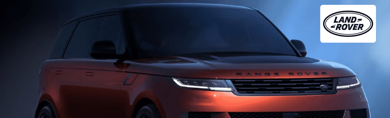 A sleek Range Rover was parked in front of Land Rover Dayton’s modern dealership building.