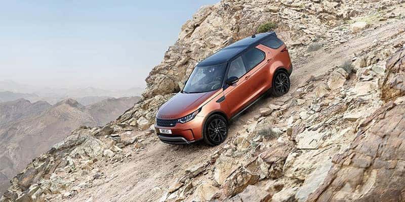 2019 Land Rover Discovery Off-Roading Down a Rocky Mountain Hill