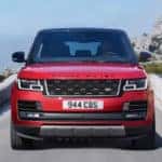 Red Range Rover driving on highway