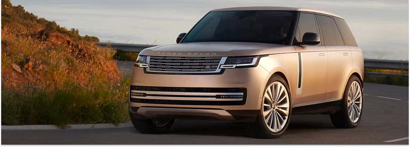 2026 Range Rover Driving on Road at Sunset