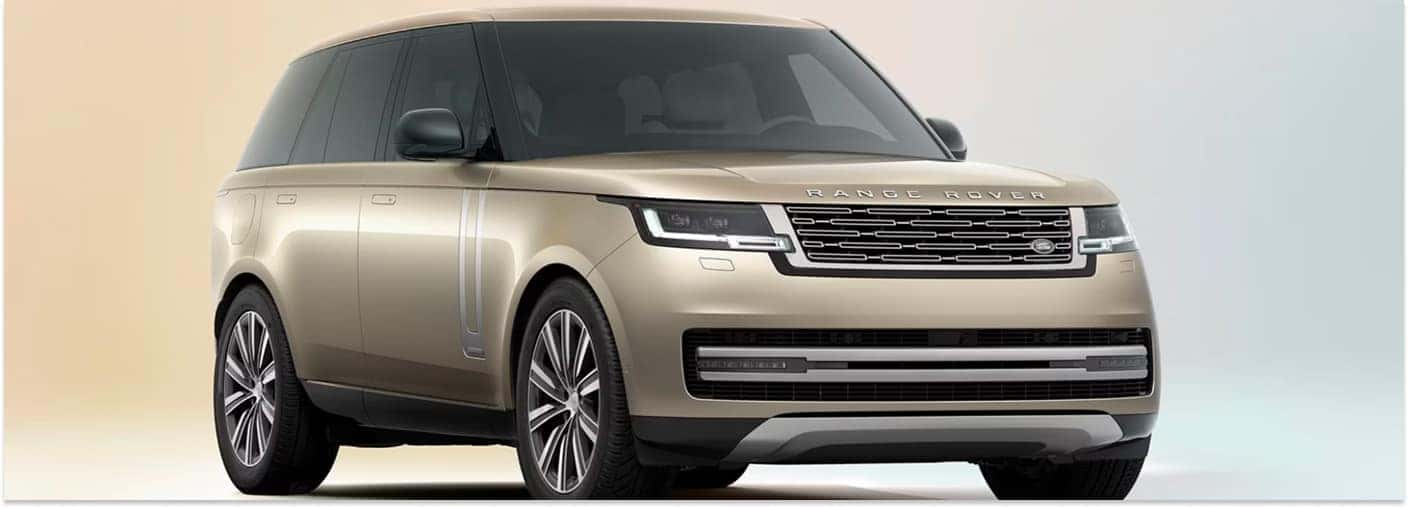 Front three-quarter view of a gold 2026 Range Rover against a neutral studio background.
