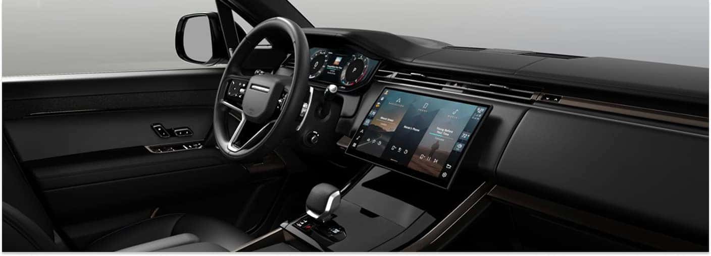Black leather interior dashboard of a 2026 Range Rover Sport with a central infotainment touchscreen.