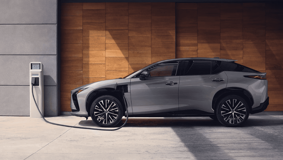 Side view of the 2023 Lexus RZ charging at a station