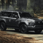 Side view of the 2024 Lexus GX driving through a forest