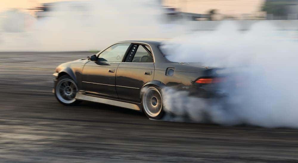 A green car is shown drifting.