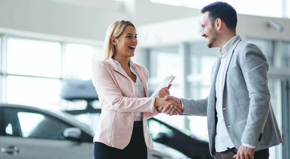 A salesperson is talking to a customer about selling their car.