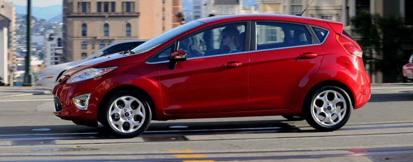 Red 2011 Used Ford Fiesta driving in a city
