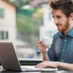 Young man connecting with a laptop at the bar